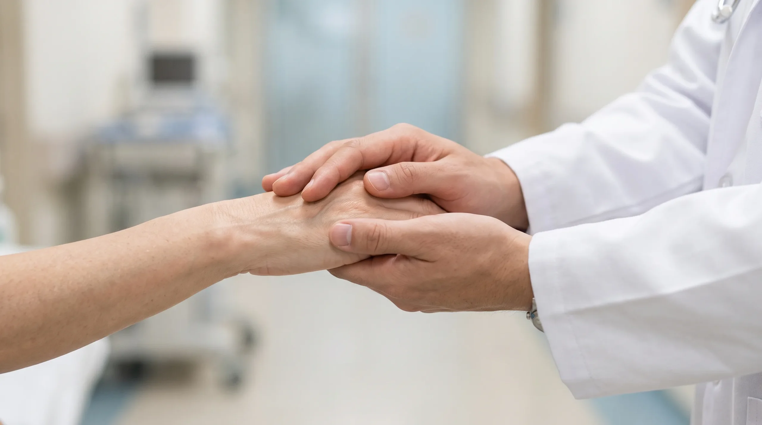 A doctor holding a patient hand at Rawat Medical Center